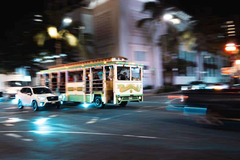 The Honolulu trolley tour bus at night
