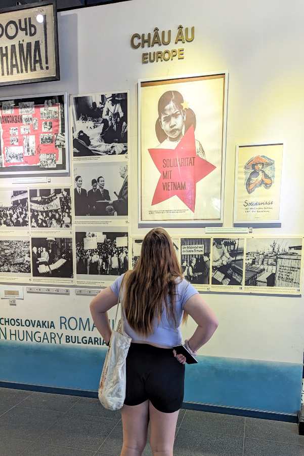 a teenager exploring the impactful exhibits of the War Remnants Museum in Ho Chi Minh City, Vietnam