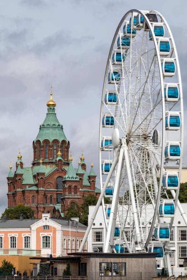 The Helsinki ferris wheel at the harbour with the cathedral in the background