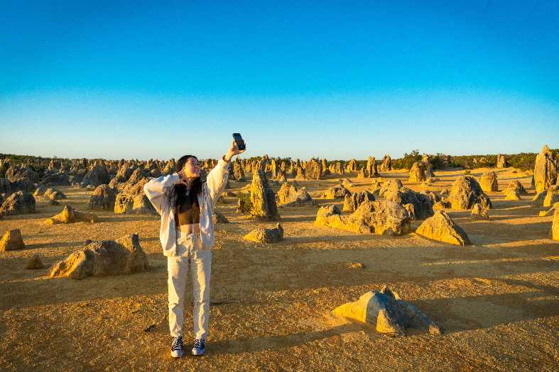 a teenage girl posing for a selfie in Nambung National Park