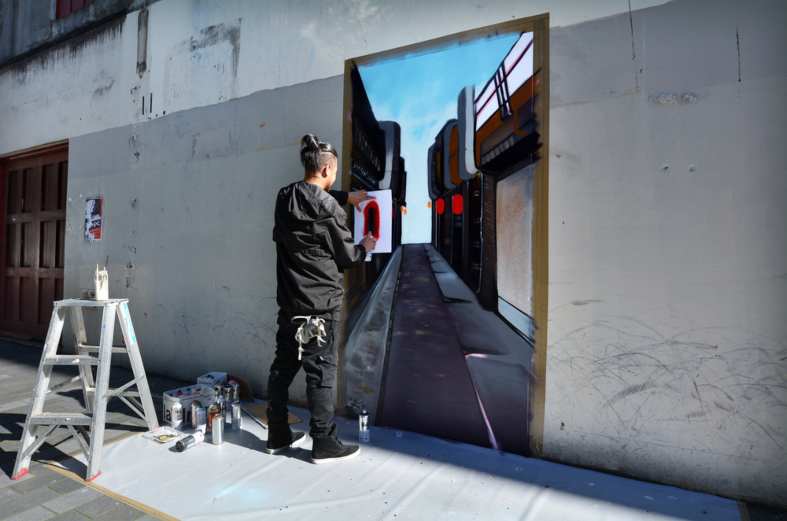 Graffiti artist paint a mural on a wall. in Auckland