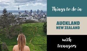 a teenager sitting on a hill overlooking Auckland
