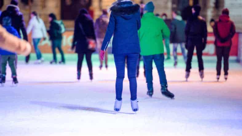 People ice skating at an indoor rink in Auckland