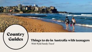 two teens walking doen the beach in Australia