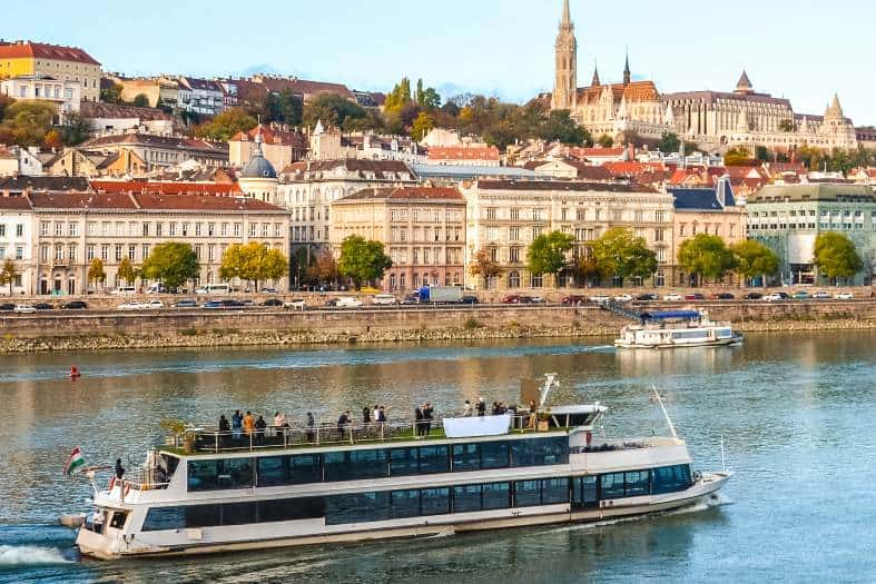 a boat cruising along the danube River in Budapest