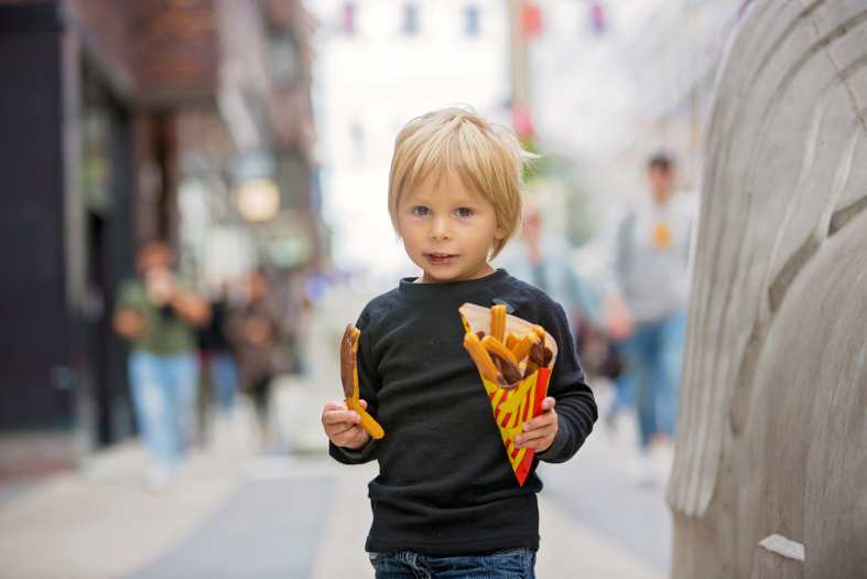 A small boy eating Churrios in Spain