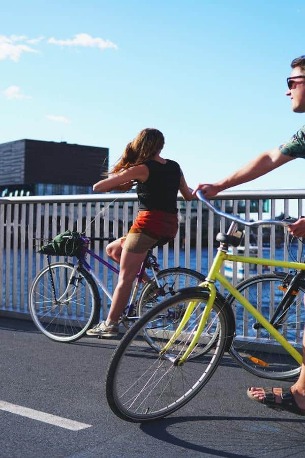 two young adults bike riding in Copenhagen
