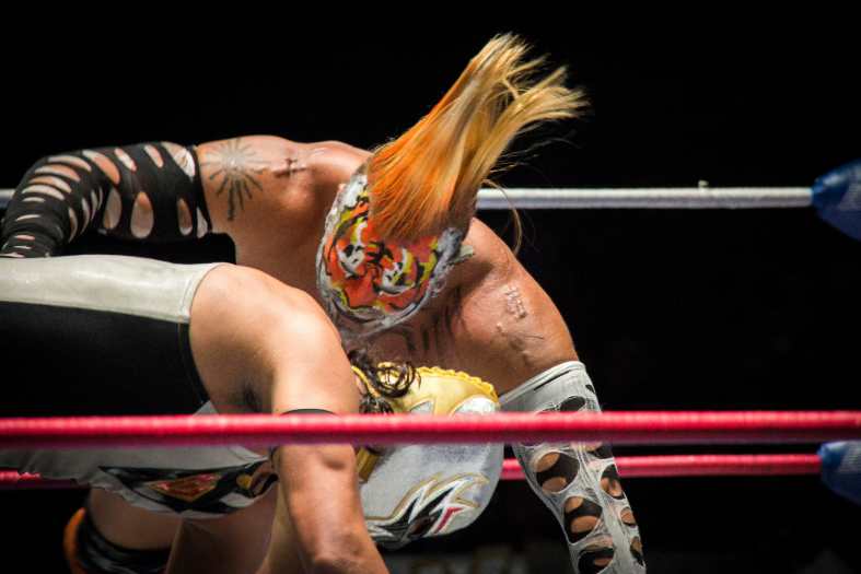 two mexican wrestlers engaged in a wrestling match
