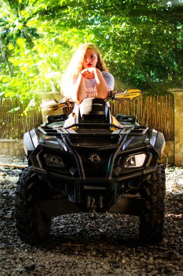 a teenage girl on an atv ready to go on a tour