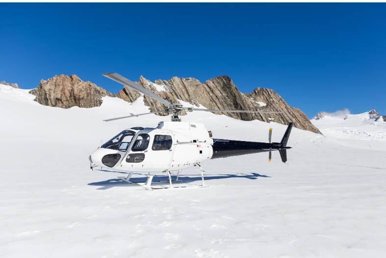 a helicopter landing on Franz Josef Glacier in New Zealand with teens