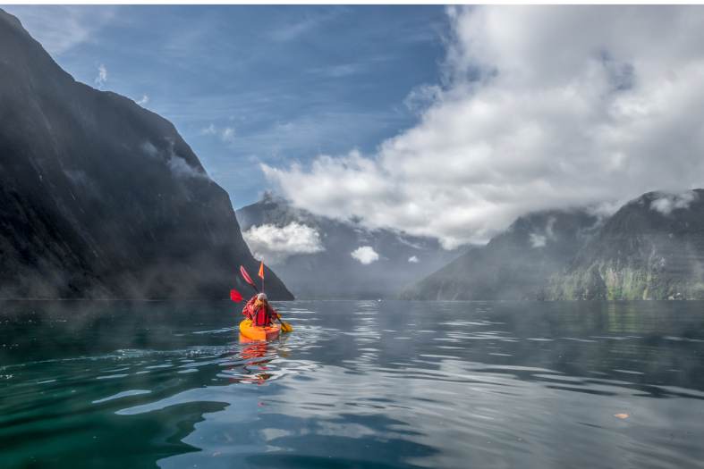teenagers kayaking on Milford Sound
