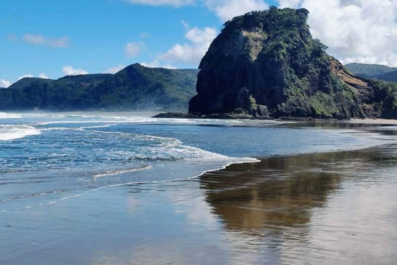 blacksand and sea stacks at Piha Beach in New Zealand