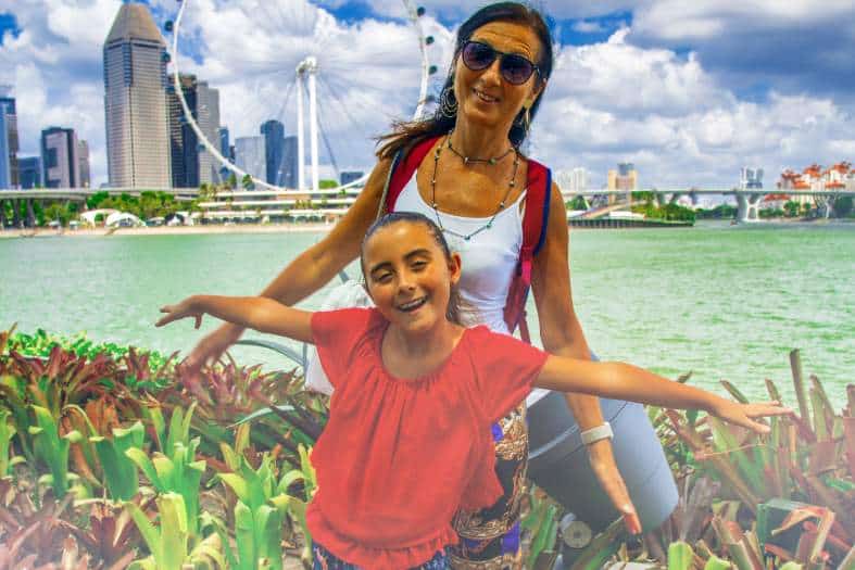 a m um and daughter exploring singapore with the singapore ferris wheel in the background