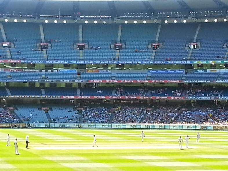 a game of cricket being played at the MCG