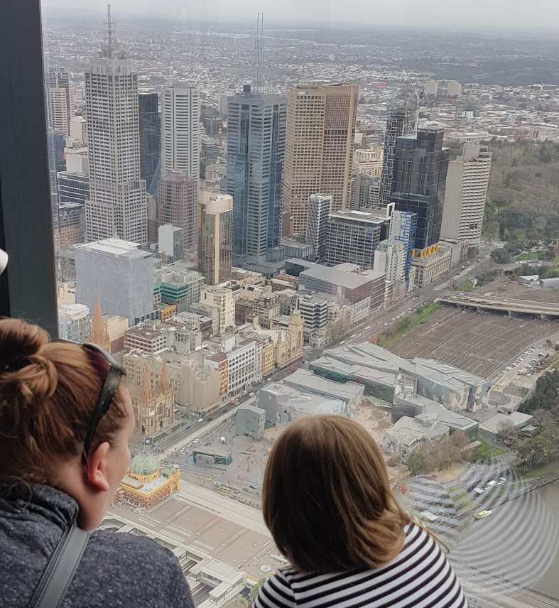 A mother and daughter looking down from the Eureka Skydeck in Melbourne