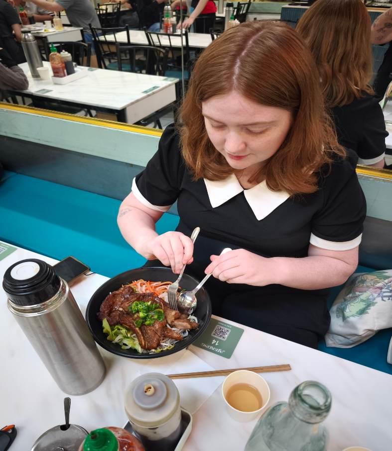 a teenage girl eating chinese noodles in melbourne