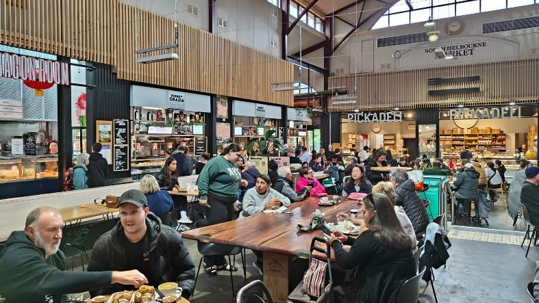 people eating in the food court at South Melbourne Market