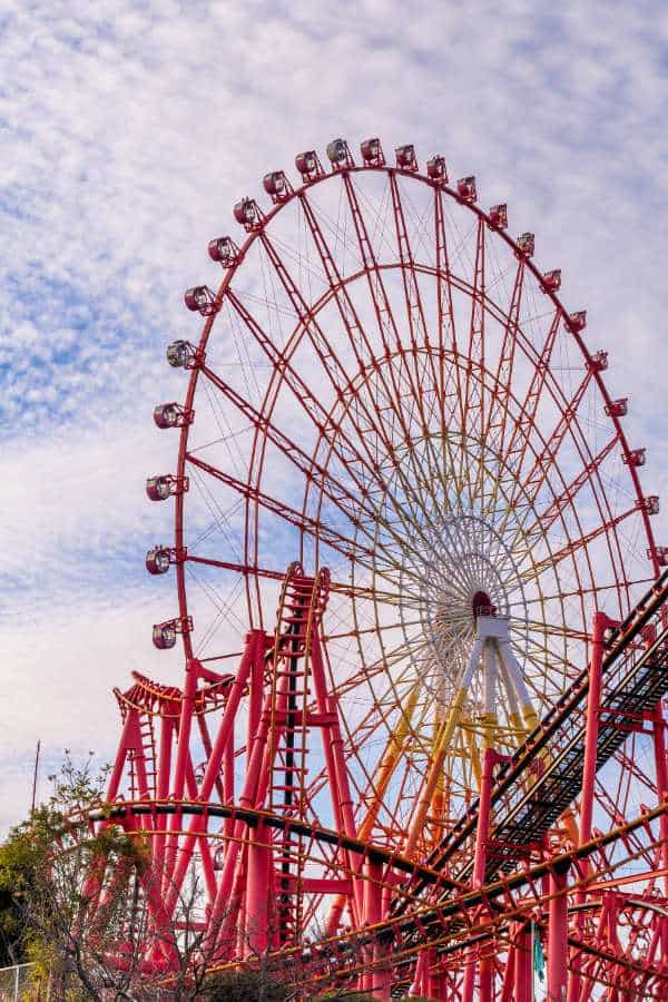 a theme park in japan with ferris wheel and rollercoaster