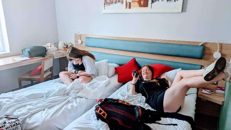 two teens in a hotel room