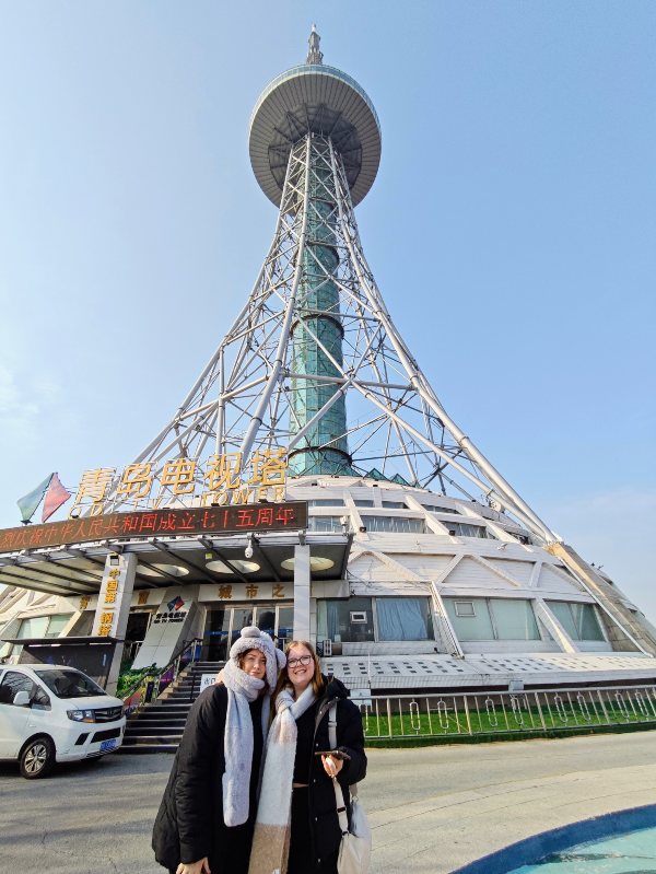 Two teenage girls standing outside the the Qingdao Tv Tower in Qingdao Shandong China